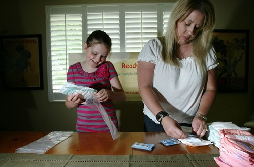 Steve Griffin  |  The Salt Lake Tribune
Nine-year-old Katelynn O'Brien, left,  came up with a unique idea for her school's invention fair: a diaper with a pocket for wipes. She and her mother, Aimee O'Brien, have patented the invention and have started a home-based business called Ready Bottoms. Here the pair make the Ready Bottoms in their Sandy, Utah home.